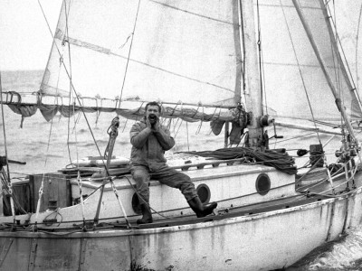 Circa 22nd April 1969: Robin Knox-Johnston hailing aboard his 32ft yacht SUHAILI off Falmouth, England after becoming the first man to sail solo non-stop around the globe. Knox-Johnston was the sole finisher in the Sunday Times Golden Globe solo round the